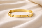 Anti-Tarnish, Ashaarya, Ashaarya Jewels, Ashaarya Jewellery, Gold bracelet with three diamonds on a beige satin background