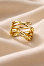 Anti-Tarnish, Ashaarya, Ashaarya Jewels, Ashaarya Jewellery, Gold ring with braided design on a beige fabric background