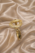 ashaarya, gold bracelet, ashaarya jewels, ashaarya jewellery, charm bracelets, gold bracelet on satin backgroundGold ring with a unique design on a beige satin background
